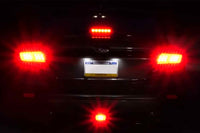 Rexpeed V2 LED Rear Fog Light for VB 2022+ Subaru WRX (G117) smoked lens red tubes installed on silver WRX at night with lights on while hitting brake lights