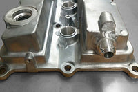 -10AN aluminum bung must be welded onto the metal valve cover